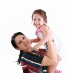 Loving Mother Lifting Her Daughter Stock Photo