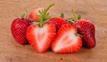 The Strawberry On Wood Background Stock Photo