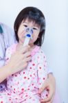 Doctor Helps Little Girl To Do Inhalation Stock Photo