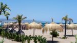 Sun Umbrellas On The Beach At Puerto Banus Stock Photo