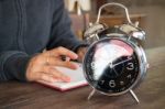 Alarm Clock On Wooden Work Table Stock Photo