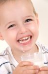 Little Laughing Boy Drinking Milk Stock Photo