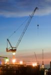 Derrick Cranes At Construction Site Stock Photo