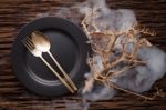 Black Empty Plate Fork Spoon On Wooden Table Background Stock Photo