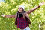 Portrait Of Beautiful Girl Standing In Autumn Field With Arms Ra Stock Photo