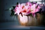 Lily Flower In Wood Bucket With Cookie Light In Home Living Room Stock Photo