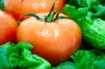 Tomato On A Background Of Green Stock Photo