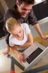 Couple At Home Using Laptop Stock Photo