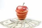 Stack Of Dollars Lays On Apple Stock Photo