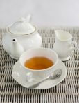 Cup Of Tea With Little Milk Jar And Teapot Stock Photo