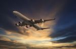 Passenger Plane Flying On Beautiful  Dusky Sky Stock Photo