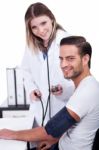 Female Doctor Checking Blood Pressure Stock Photo