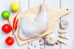 Culinary Background With Spices And Chicken Drumstick On Wooden Table Stock Photo