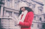 Beautiful Woman In Red Coat And Wool Cap And Gloves With Smartph Stock Photo