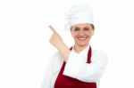 Aged Woman Chef Pointing Up Stock Photo