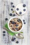 Bowl Of Muesli With Fresh Blueberries And Glass Of Yogurt On Whi Stock Photo