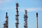 Distillation Towers On Blue Sky Background Stock Photo