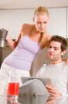 Couple In Kitchen Having Breakfast Stock Photo