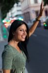 Young Girl Calling A Taxi In The City At Night Stock Photo