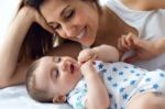 Mother And Baby Playing And Smiling At Home Stock Photo