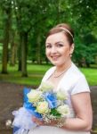 Young Smiling Bride With A Bouquet Of Roses Stock Photo