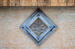 Perforated Wood Within Wooden Frame On Old Brick Wall Background Stock Photo