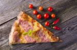 Pizza Cut On Wooden Table Stock Photo