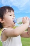 Little Asian Girl  Drinking Water From Plastic Bottle Stock Photo