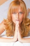 Young Lady Praying In Bed Stock Photo