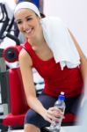 Young Woman Relaxing In The Gym After Making Exercise Stock Photo