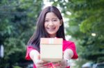 Portrait Of Thai Teen Beautiful Girl In Chinese Dress, Happy New Year And Open Box Gift, Smile And Very Happy Stock Photo