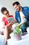 Two Business People Using A Digital Tablet At Office Stock Photo