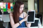 Portrait Of Thai Adult Beautiful Girl Using Her Tablet And Smile In University Stock Photo