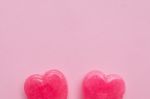 Two Pink Valentine's Day Heart Shape Lollipop Candy On Empty Pastel Pink Paper Background. Love Concept. Top View. Minimalism Colorful Hipster Style Stock Photo