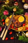 Christmas Baked Duck Served With Potatoes, Orange And Tomatoes Stock Photo