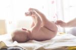 Mom Carefully Clean Baby Skin With Wet Wipes Stock Photo