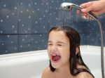 Mom Pours A Little Girl Out Of The Shower Stock Photo