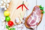 Culinary Background With Spices And Pork On Wooden Table Stock Photo