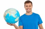 Young Male Holding Globe Stock Photo