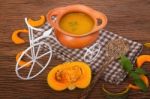 Pumpkin Soup In Clay Pot With Fresh Pumpkins Stock Photo