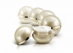 Several Golden Sphere Cosmetic Jar On White Background Stock Photo