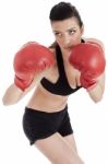 Sporty Girl In Boxing Gloves Punching Stock Photo