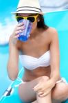 Beautiful Girl Drinking Water At The Swimming Pool Stock Photo