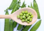 Peas On Wooden Spoon Stock Photo