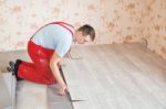 Handyman Laying Down Laminate Flooring Boards Stock Photo