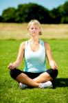 Woman Meditating Outdoors On A Sunny Day Stock Photo