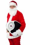 Aged Male Santa Holding Weighing Scale Stock Photo