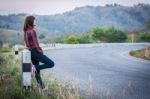 Tourist Hitchhiking Woman Standing On The Road In The Mountains Stock Photo