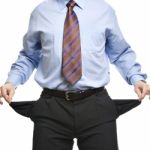 Businessman Showing Empty Pockets Stock Photo