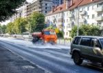 Cleaning Machine Washing The City Asphalt Road With Water Spray Stock Photo